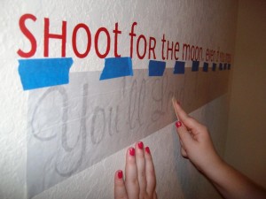 Rubbing the vinyl letters against the wall